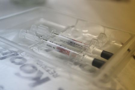 Two doses of H1N1 flu vaccine are placed on the desk at the 157 Public Elementary School, where students can receive the vaccin, in New York, the United States, October 28, 2009. New York City began its school-based H1N1 influenza vaccination campaign on Wednesday. The frist phase of the three-stage initiative started at 125 schools with enrollment of less than 400.