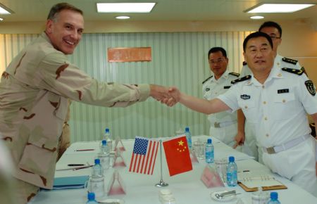 Scott Sanders (L), commander of the US 151 Task Formation Fleet, shakes hands with Wang Zhiguo, commander of the Chinese third convoy fleet to the Gulf of Aden, on China&apos;s &apos;Zhongshan&apos; warship November 1, 2009. Scott Sanders and his entourage paid a visit to &apos;Zhongshan&apos; warship at the invitation of Wang Zhiguo on Sunday local time.