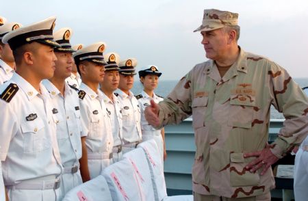 Scott Sanders (R), commander of the US 151 Task Formation Fleet, talks with Chinese soldiers on the Chinese warship of &apos;Zhongshan&apos; at the Gulf of Aden November 1, 2009.