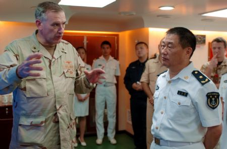 Scott Sanders (L), commander of the US 151 Task Formation Fleet, talks with Wang Zhiguo (R), commander of the Chinese third convoy fleet to the Gulf of Aden, on the Chinese warship of &apos;Zhongshan&apos; at the Gulf of Aden November 1, 2009.