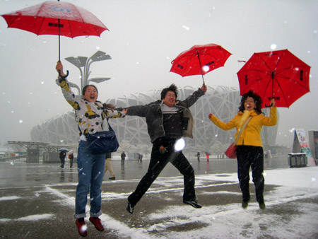 Tourists enjoy themselves in front of the National Stadium in Beijing November 1, 2009. 