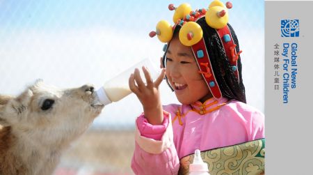 Ceyun Bainco feeds a young Tibetan antelope at Sonam Daje Natural Protection Station in Hol Xil Natural Reserve in Northwest China's Qinghai Province, October 23, 2009.