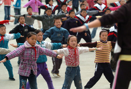 Students do exercises to radio music at the class interval at the Jinzhai County&apos;s Hope Primary School, in Jinzhai, east China&apos;s Anhui Province, October 27, 2009.