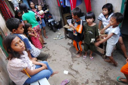 Indonesian girl Nurul, nine-year-old, plays with her friends in a slum area in Jakarta October 25, 2009.