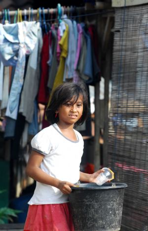 Indonesian girl Nurul, nine-year-old, cleans the plastic cups she collects from trash in Jakarta May 25, 2009.