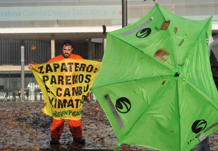 A Greenpeace activist displays a banner during a demonstration outside the venue of the UN 2009 5th Climate Change Talks in Barcelona, Spain, November 5, 2009.