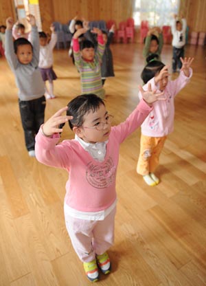 Song Xinyi, an earthquake orphan, gestures during a dancing class in her kindergarten in Chengdu, capital city of southwest China's Sichuan Province, on October 26, 2009. 