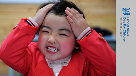 Song Xinyi, an earthquake orphan, smiles in her kindergarten in Chengdu, capital city of southwest China's Sichuan Province, on October 26, 2009.