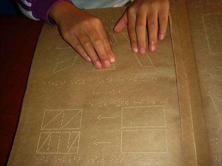 Photo taken by Zhao Congrui shows that a student reads Braille in Tianjin School for the Visually Impaired in Tianjin, north China, October 28, 2009. 