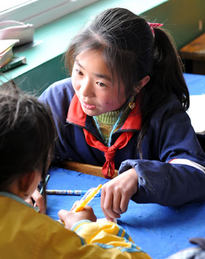 Hai Qin, a 12-year-old girl of Hui ethnic group, communicates with her classmate, in Kaicheng Town of Guyuan City, northwest China&apos;s Ningxia Hui Autonomous Region, Oct. 23, 2009.