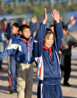 Hai Qin, a 12-year-old girl of Hui ethnic group, stretches body during the morning calisthenics of all students on campus, in Kaicheng Town of Guyuan City, northwest China&apos;s Ningxia Hui Autonomous Region, Oct. 23, 2009.