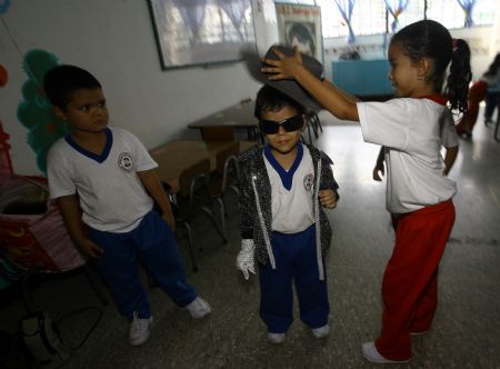 Jose Manuel Sanchez Aguero, a five-year-old boy, prepares before imitating Michael Jackson at school in Barquisimeto, Venezuela, Oct. 30, 2009. 