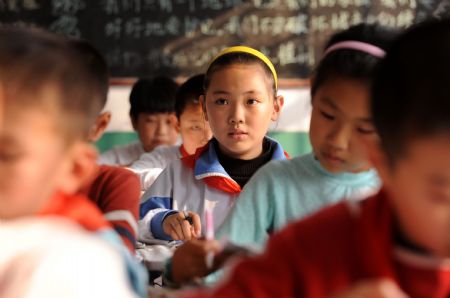 Liu Mengyi (C) listens at her school in Qingdao, east China's Shandong Province, October 26, 2009.