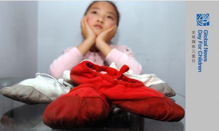 Liang Yuxin poses with her favourite dancing shoes in Harbin, capital of northeast China's Heilongjiang Province, October 28, 2009.