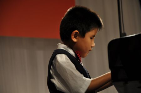 Liu Hao, an eight-year-old blind boy of a worker's family, plays piano during the shooting of a film narrating the story of his own, in Chifeng City, north China's Inner Mongolia Autonomous Region, January 5, 2008.