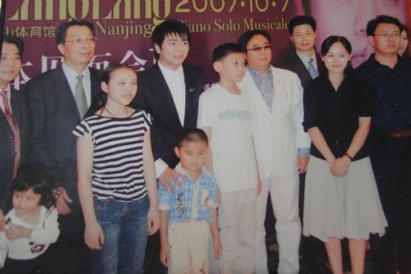 Photo taken on October 7, 2007 shows Liu Hao, an eight-year-old blind boy of a worker's family in Chifeng City, north China's Inner Mongolia Autonomous Region, posing for a group photo with Lang Lang and other musical celebrities.