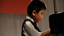 Liu Hao, an eight-year-old blind boy of a worker's family, plays piano during the shooting of a film narrating the story of his own, in Chifeng City, north China's Inner Mongolia Autonomous Region, January 5, 2008.