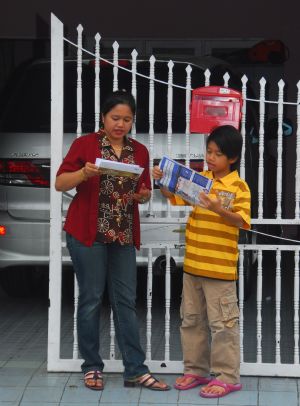 Adi Putra checks mails with his mother at home in Gombak District, Selangor State, Malaysia, on October 7, 2009. 