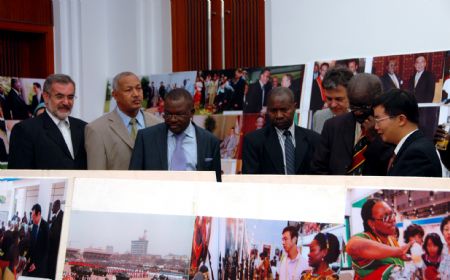 Guests visit a photo exhibition at the Chinese Embassy in Kampala, capital of Uganda, November 9, 2009. 