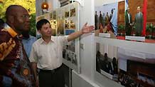 Yu Qiuzhong (R), Charge d'Affairs of China's Embassy to the Democratic Republic of Congo (DRC), briefs the exhibited photos to guests during a photo exhibition at the Chinese Embassy in Kinshasa, capital of DRC, November 9, 2009. The photo exhibition opened here on Monday, in a move to showcase the achievements of follow up actions of the Beijing Summit of the Forum on Sino-Africa Cooperation.