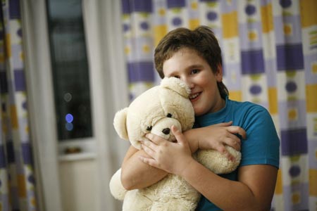 Photo taken on October 26, 2009 shows Dobrynin Denis holds his toy bear at home in Moscow, capital of Russia.