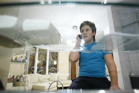 Photo taken on October 26, 2009 shows Dobrynin Denis answers a phone call at home in Moscow, capital of Russia. 