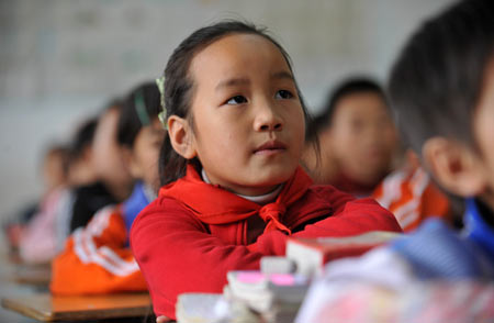 Gao Yaqian, an 8-year-old pupil of the Central Primary School of Lirang Town, attends a Chinese-language class, in Liangping County, southwest China's Chongqing municipality, October 30, 2009. 