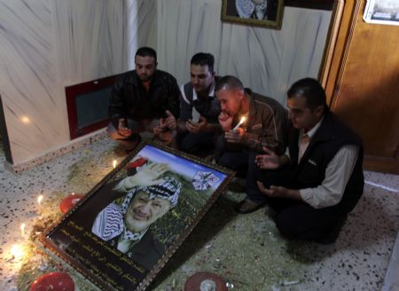 Fatah officials take part in a candle-lighting ceremony to mark the 5th anniversary of late Palestinian leader Yasser Arafat' death in an office in southern Gaza Strip town of Rafah on November 10, 2009, a move to defy Hamas's ban on marking the death anniversary of Arafat in Gaza Strip. The event used to be a mass gathering in the Palestinian territories, but Hamas, which seized control of Gaza in 2007, has banned public activities on this occasion for two years. 