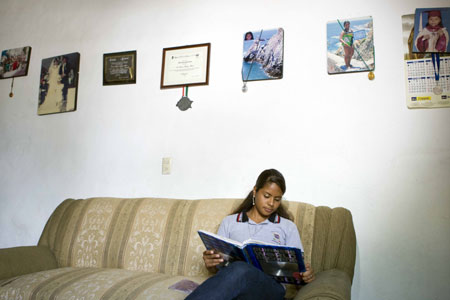 Mexican girl Iris Alvarez reads a book at home in Acapulco, Mexico, October 30, 2009.