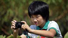 The undated photo shows Zhu Mengdan taking pictures in south China's Guangdong Province. My name is Zhu Mengdan, 11 years old and a fifth-grade pupil of the Experimental Primary School of Zhaoqing City, in south China's Guangdong Province.