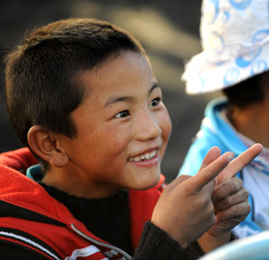 Dainzin Gyayang makes faces in the Lijiang Ethnic Orphanage in Lijiang City, southwest China's Yunnan Province, October 24, 2009. 