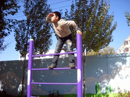 This photo I took on October 13, 2009 shows a boy overlooking on a sports apparatus. 