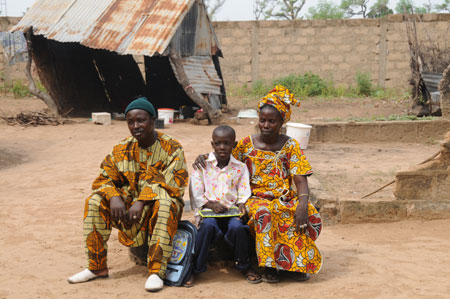 Seven-year-old Lamine poses with his parents at home in a village 80 kilometers north of Dakar, capital of Senegal, October 27, 2009.