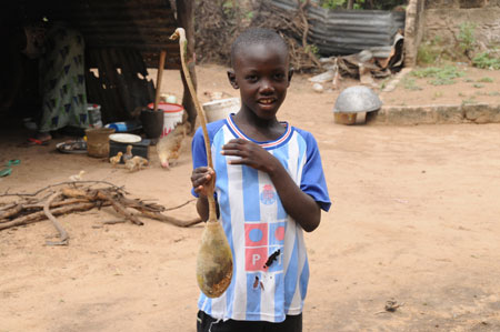 Seven-year-old Lamine holds the breadfruit at home in a village 80 kilometers north of Dakar, capital of Senegal, October 27, 2009. 