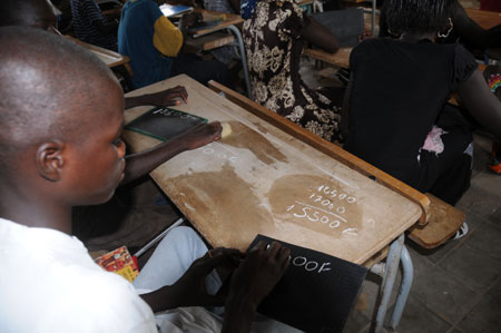 Lamine calculates during a math class at school in a village 80 kilometers north of Dakar, capital of Senegal, October 27, 2009. 