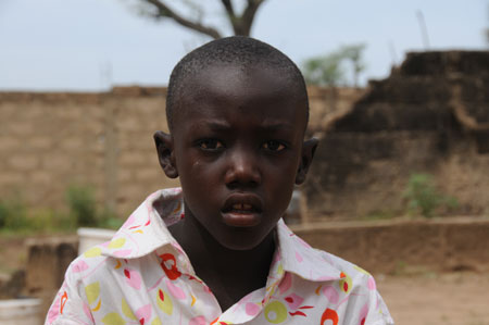 Photo taken on October 27, 2009 shows seven-year-old Lamine standing in a village 80 kilometers north of Dakar, capital of Senegal.