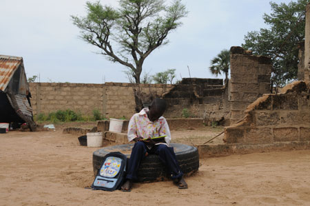 Seven-year-old Lamine reviews homework in a village 80 kilometers north of Dakar, capital of Senegal, October 27, 2009. 