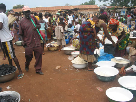 The photo taken on October 28, 2009 shows local residents trade at the market in Togoville. Wednesday is the busiest time of a week. At this market barter trade that has died out in most of the markets, is still performed as fishers barter their fishes for grain products from local farmers without using any cash.