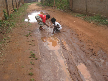 The photo taken on October 28, 2009 shows on my way home I saw two kids play with mud in Togoville.