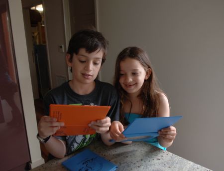 Photo taken on November 3, 2009 shows Jordan Hartman and his sister reviewing his design chart on environment protection at home in Melbourne of Australia.