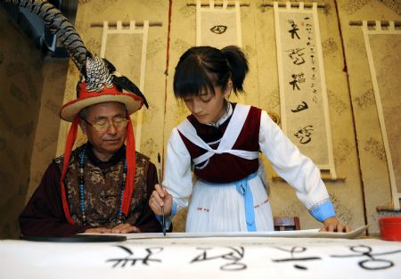 He Siqi learns to write characters of the language of the Naxi ethnic group in Lijiang City, southwest China&apos;s Yunnan Province, October 26, 2009.