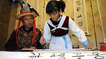 He Siqi learns to write characters of the language of the Naxi ethnic group in Lijiang City, southwest China's Yunnan Province, October 26, 2009.
