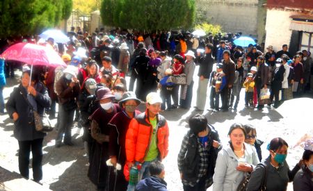 The photo I took on October 31, 2009 shows Buddhism disciples waiting for worship in Lhasa.