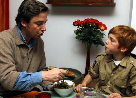 George (R) talks with his dad at home in Paris, November 9, 2009.