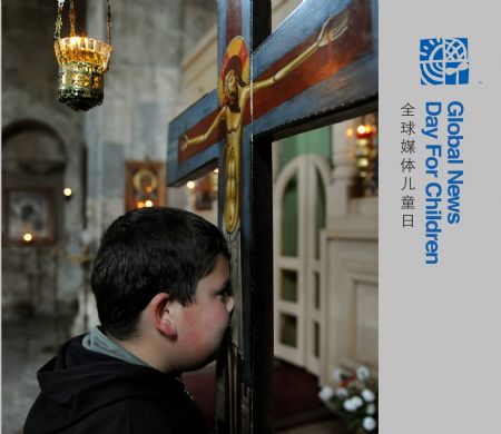 Alika kisses a cross in a church at north-nikodze village in central-north Georgia, on November 5, 2009. 'My name is Alika and I'm nine years old', says Alika, 'I study in the 5th grade of the only school in the village.'