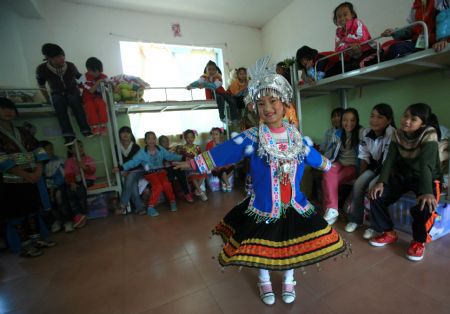 Wang Jinlian dances for friends in her dormitory in the Neil Taylor Care Center in Rongshui Miao Autonomous County, southwest China's Guangxi Zhuang Autonomous Region, November 6, 2009.