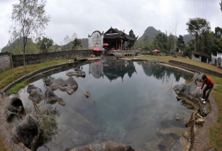 Photo taken on November 15, 2009 shows a drama stage with 500 years' history is reflected in water at Fuxi Village with lots of ancient architectures that date to the Ming and Qing Dynasties in Fuchuan Yao Autonomous County, southwest China's Guangxi Zhuang Autonomous Region.