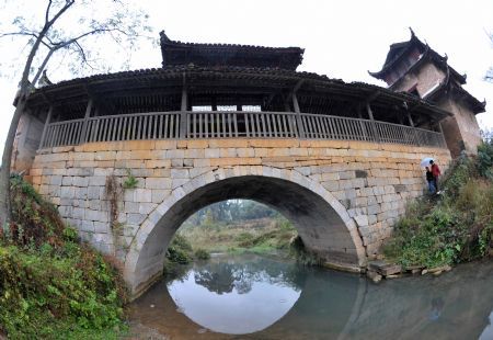 Photo taken on November 15, 2009 shows Qinglong Wind-rain Bridge at Fuxi Village with lots of ancient architectures that date to the Ming and Qing Dynasties in Fuchuan Yao Autonomous County, southwest China's Guangxi Zhuang Autonomous Region.