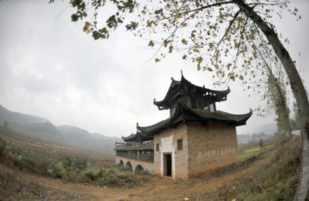 Photo taken on November 15, 2009 shows Huilan Wind-rain Bridge of the Ming Dynasty at Youmu Village with lots of ancient architectures that date to the Ming and Qing Dynasties in Fuchuan Yao Autonomous County, southwest China's Guangxi Zhuang Autonomous Region.