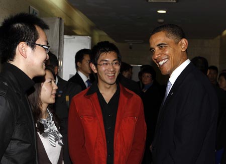 US President Barack Obama talks with Chinese students before delivering a speech at a dialogue with Chinese youth at the Shanghai Science and Technology Museum during his four-day state visit to China, November 16, 2009.